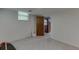 Unfinished basement with one window and a view into another room with a wood door at 3460 Wycherly Ne Ct, Brookhaven, GA 30319