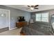 Comfortable bedroom with dresser, TV and chair; window with lots of natural light and a ceiling fan at 3460 Wycherly Ne Ct, Brookhaven, GA 30319