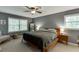 Comfortable bedroom with natural light, ceiling fan and a bed with a dark quilt, and a basket at 3460 Wycherly Ne Ct, Brookhaven, GA 30319