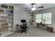 Well-lit bedroom or office space featuring built-in shelving, ceiling fan, and ample natural light at 3460 Wycherly Ne Ct, Brookhaven, GA 30319