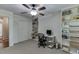 Well-lit bedroom or office space featuring built-in shelving, ceiling fan, and ample storage at 3460 Wycherly Ne Ct, Brookhaven, GA 30319