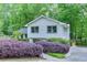Charming two-story home with a light blue door and beautifully landscaped front yard surrounded by lush green trees at 3460 Wycherly Ne Ct, Brookhaven, GA 30319