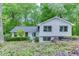 Charming two-story home with a light blue door and beautifully landscaped front yard surrounded by lush green trees at 3460 Wycherly Ne Ct, Brookhaven, GA 30319