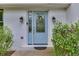 Inviting front entrance features a light blue door with glass sidelights and charming outdoor lighting at 3460 Wycherly Ne Ct, Brookhaven, GA 30319