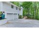 Spacious two car garage with additional parking on a newly paved drive, surrounded by mature trees at 3460 Wycherly Ne Ct, Brookhaven, GA 30319