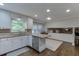 Efficient kitchen layout with stainless steel appliances, granite counters, and hardwood floors at 3460 Wycherly Ne Ct, Brookhaven, GA 30319