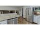Bright kitchen features stainless steel appliances, granite countertops, and beautiful hardwood floors at 3460 Wycherly Ne Ct, Brookhaven, GA 30319