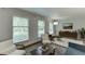 Bright living room with floor to ceiling windows, neutral walls and modern decor at 3460 Wycherly Ne Ct, Brookhaven, GA 30319