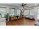 Bright living room featuring hardwood floors, large windows, ceiling fan, and stylish furniture at 3460 Wycherly Ne Ct, Brookhaven, GA 30319