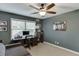 Comfortable home office with a computer desk, ceiling fan, and natural light from the window at 3460 Wycherly Ne Ct, Brookhaven, GA 30319