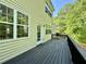 A well-maintained back deck with dark stain, ideal for outdoor relaxation and overlooking the green backyard at 3650 Deep Cove Dr, Cumming, GA 30041
