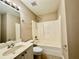 Bathroom with shower over tub and single sink vanity at 3650 Deep Cove Dr, Cumming, GA 30041