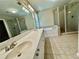 Bathroom featuring double sink vanity, bathtub, and walk-in shower at 3650 Deep Cove Dr, Cumming, GA 30041