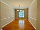 Bright dining room featuring hardwood floors, elegant chandelier, and natural light at 3650 Deep Cove Dr, Cumming, GA 30041
