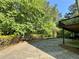 Long concrete driveway that leads to a house with a 2-car garage, surrounded by lush greenery at 3650 Deep Cove Dr, Cumming, GA 30041
