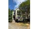 Charming two-story townhome with a well-manicured lawn, complemented by mature trees and a blue sky backdrop at 3650 Deep Cove Dr, Cumming, GA 30041