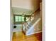 Inviting foyer with hardwood floors, staircase with wood railing, and view into the living room at 3650 Deep Cove Dr, Cumming, GA 30041