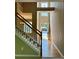 Welcoming foyer with hardwood floors, a staircase, and a view of the front door and neighborhood at 3650 Deep Cove Dr, Cumming, GA 30041