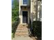 Charming home entrance featuring stone steps, iron railings, and a classic black front door at 3650 Deep Cove Dr, Cumming, GA 30041