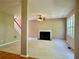 Spacious living room with a fireplace, ceiling fan, and an abundance of natural light from large windows at 3650 Deep Cove Dr, Cumming, GA 30041