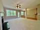 Bright living room with fireplace, large windows, carpet, and adjoining hardwood floor space at 3650 Deep Cove Dr, Cumming, GA 30041