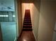 View of a wooden staircase with a handrail and painted walls leading upstairs from a garage at 3650 Deep Cove Dr, Cumming, GA 30041
