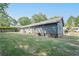 Well-maintained backyard featuring lush greenery and the home's exterior with blue siding at 554 Cana Of Galilee Ct, Tucker, GA 30084