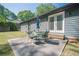 Comfortable backyard patio with outdoor seating, umbrella, and manicured lawn at 554 Cana Of Galilee Ct, Tucker, GA 30084