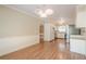 Spacious dining room with modern light fixture that adjoins an updated kitchen at 554 Cana Of Galilee Ct, Tucker, GA 30084