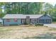 Charming home with a well-manicured lawn, blue siding and red shutters at 554 Cana Of Galilee Ct, Tucker, GA 30084