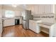 Updated kitchen with white cabinets, granite counters, stainless steel appliances and wood floors at 554 Cana Of Galilee Ct, Tucker, GA 30084