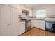 Kitchen with white cabinets, granite countertops, stainless oven, backsplash and wood floors at 554 Cana Of Galilee Ct, Tucker, GA 30084