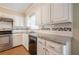 Updated kitchen featuring granite countertops, subway tile backsplash, and stainless steel appliances at 554 Cana Of Galilee Ct, Tucker, GA 30084