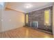 Cozy living room featuring a brick fireplace, mantle, and wood-look flooring at 554 Cana Of Galilee Ct, Tucker, GA 30084