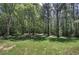 The home features a large, grassy backyard and mature trees, offering privacy and shade at 899 Marshall Fuller Rd, Dallas, GA 30157