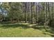 The home features a large, grassy backyard and mature trees, offering privacy and shade at 899 Marshall Fuller Rd, Dallas, GA 30157