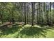 The home features a large, grassy backyard and mature trees, offering privacy and shade at 899 Marshall Fuller Rd, Dallas, GA 30157