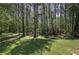The home features a large, grassy backyard and mature trees, offering privacy and shade at 899 Marshall Fuller Rd, Dallas, GA 30157