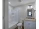 Bathroom with shower/tub combo, mirror and wood-look vanity at 899 Marshall Fuller Rd, Dallas, GA 30157