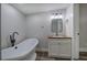 Bathroom featuring modern vanity and freestanding tub with black fixtures at 899 Marshall Fuller Rd, Dallas, GA 30157