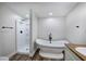 Bathroom showcasing a freestanding tub and a glass-enclosed shower at 899 Marshall Fuller Rd, Dallas, GA 30157