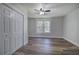Bright bedroom with hardwood floors, ceiling fan, and double door closet at 899 Marshall Fuller Rd, Dallas, GA 30157