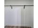 Walk-in closet with wood-look flooring and clothes hanging bar at 899 Marshall Fuller Rd, Dallas, GA 30157