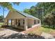 This single-story home includes a covered porch with brick and wood supports, set within a quiet, wooded landscape at 899 Marshall Fuller Rd, Dallas, GA 30157