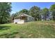 Exterior view of the home and yard, showing a covered porch and crawl space foundation at 899 Marshall Fuller Rd, Dallas, GA 30157