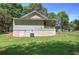 Exterior view of the home and yard, showing a covered porch and crawl space foundation at 899 Marshall Fuller Rd, Dallas, GA 30157