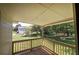 Covered front porch features a wooden deck and railing, offering an outdoor seating area at 899 Marshall Fuller Rd, Dallas, GA 30157