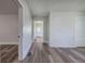 Hallway with wood-look floors and painted shiplap walls offers clear sightlines through the home at 899 Marshall Fuller Rd, Dallas, GA 30157
