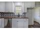 Bright kitchen features stainless steel sink, modern cabinets, and starburst backsplash at 899 Marshall Fuller Rd, Dallas, GA 30157