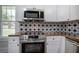 New stainless steel appliances accent updated kitchen with stylish countertop and backsplash at 899 Marshall Fuller Rd, Dallas, GA 30157